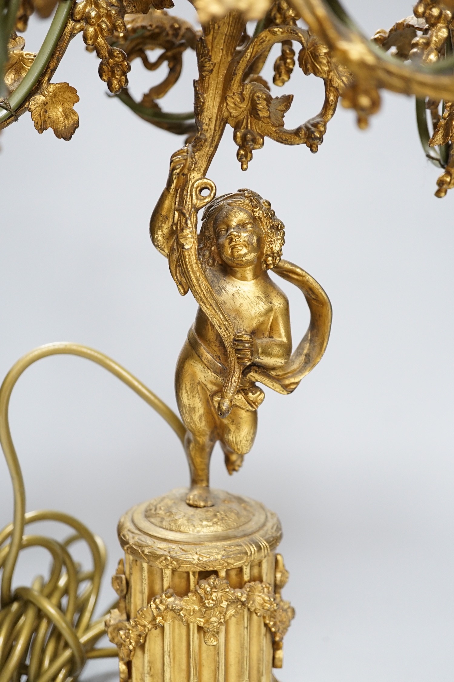 An ornate six branch ormolu cherub candelabrum, converted to a lamp, 54cms high